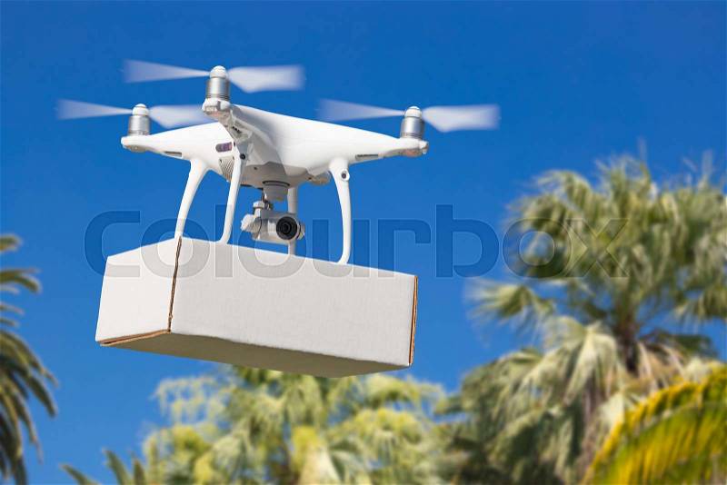 Unmanned Aircraft System (UAV) Quadcopter Drone Carrying Blank Package Over Tropical Terrain, stock photo