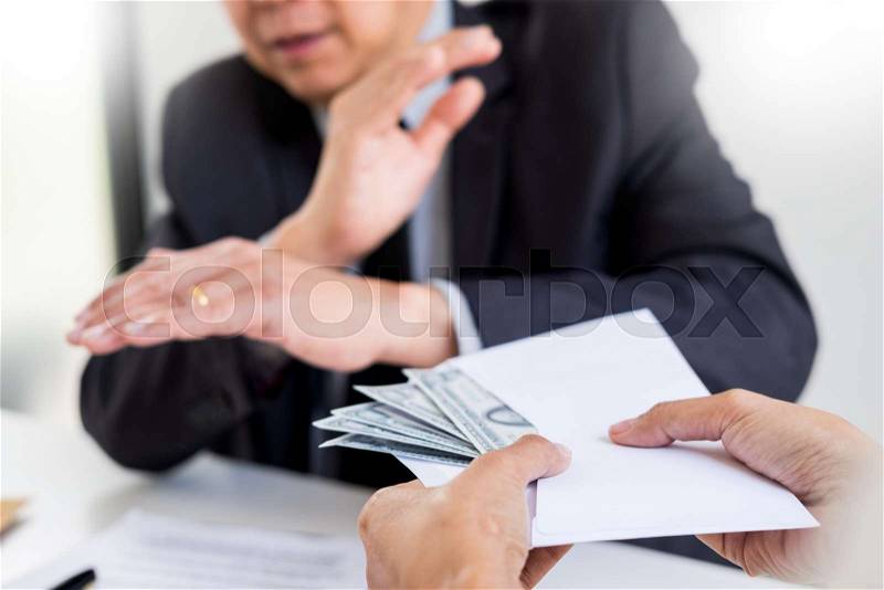 Businessman refusing or rejecting money in the envelope - anti bribery and corruption concepts, stock photo