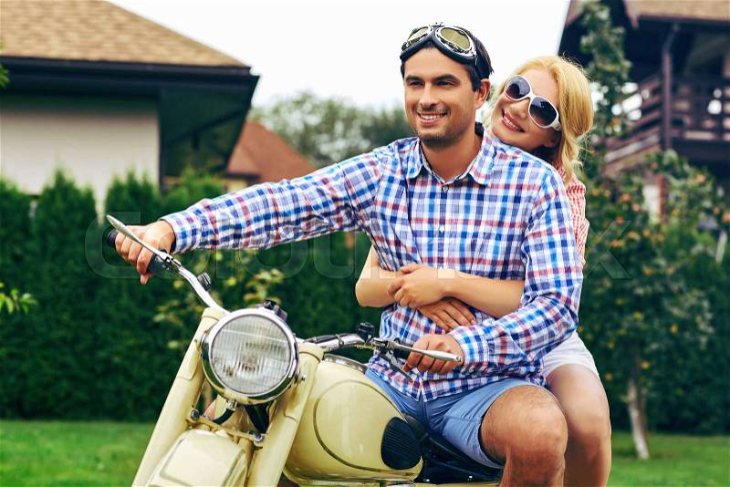 Beautiful woman and hansome man on retro intage motorbike. couple in love. outdoor shot with ambient light. copy space, stock photo