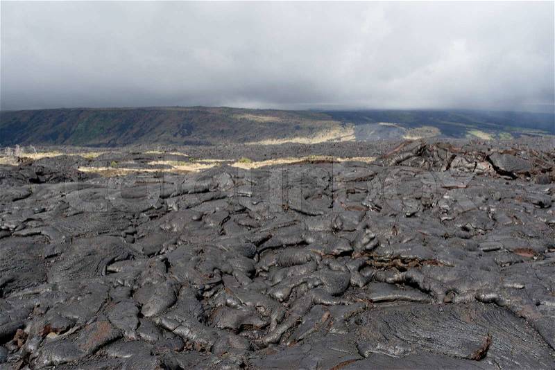 Volcanic lava field on Big island, Hawaii on cloudy day, stock photo