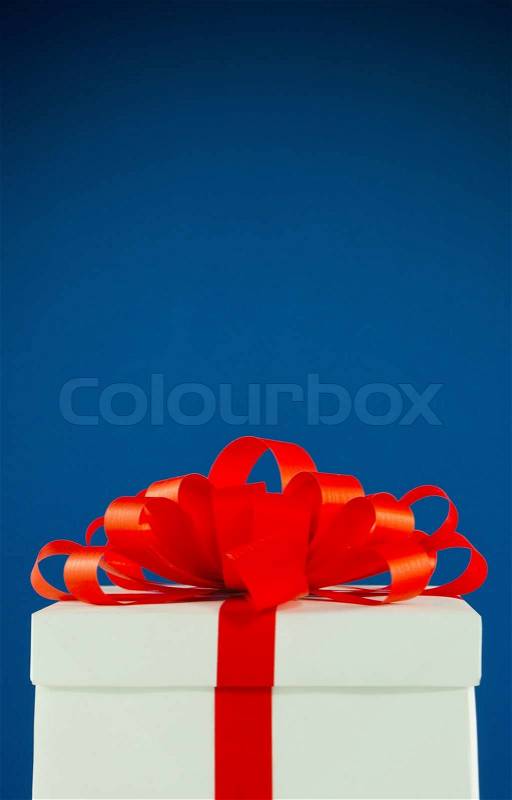 White box with present against blue background, stock photo