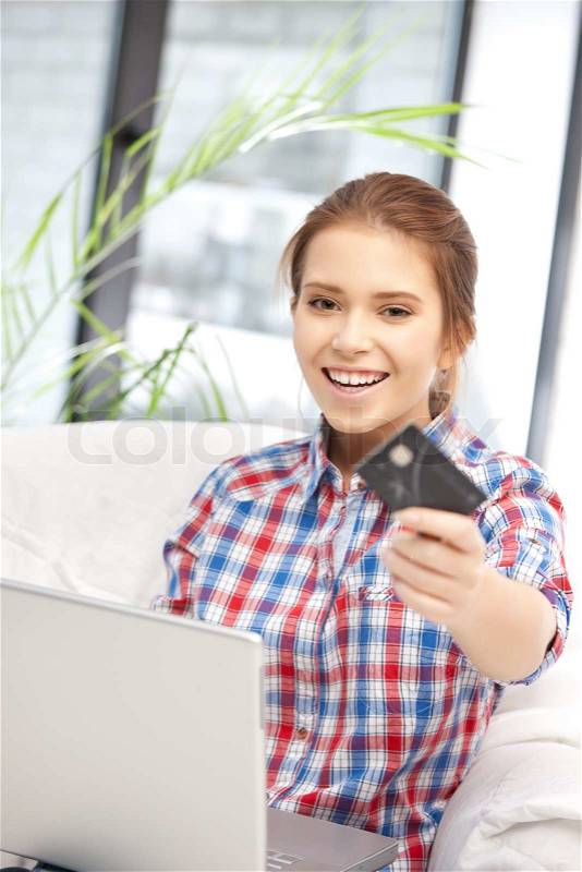 Picture of happy woman with laptop computer and credit card, stock photo