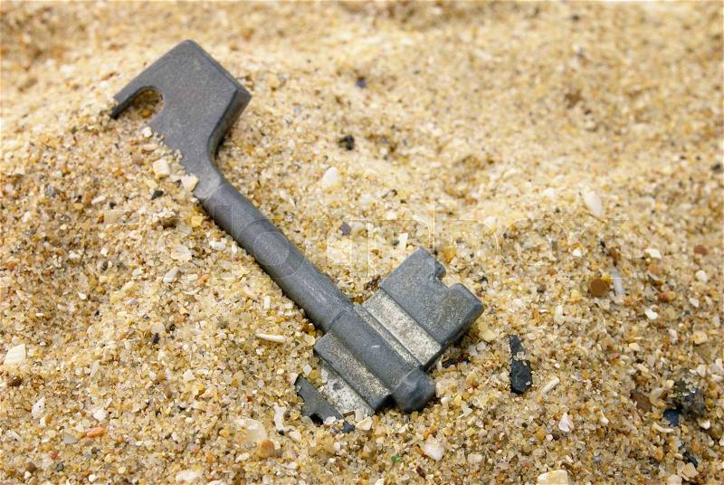 The old key which has been filled up by sand, stock photo