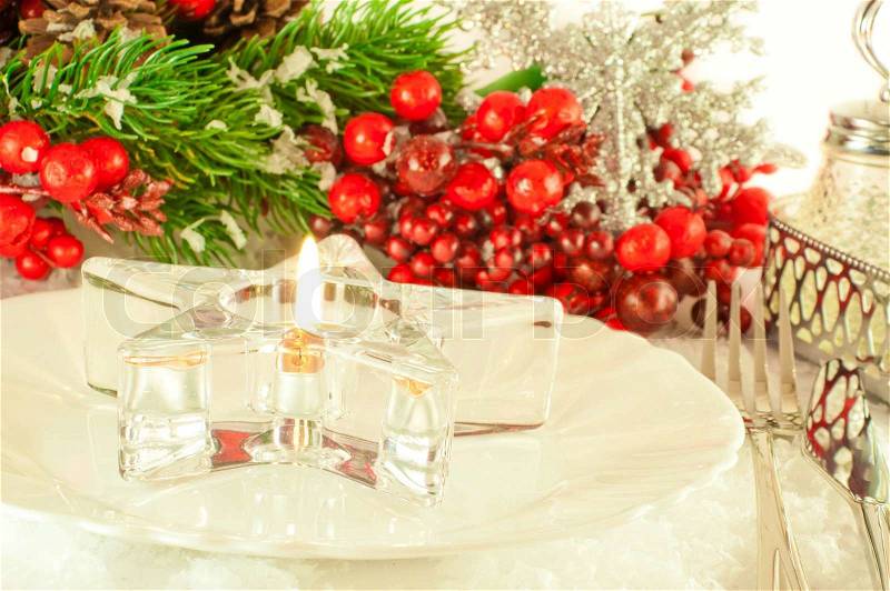 Christmas table layout, candlestick in the form of a star with a branch of berries, stock photo