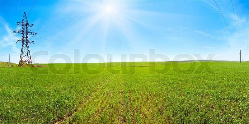 Spring green cereals field morning panorama, blue sky with sunshine patch and plane traces high-voltage line Four shots stitch image, stock photo