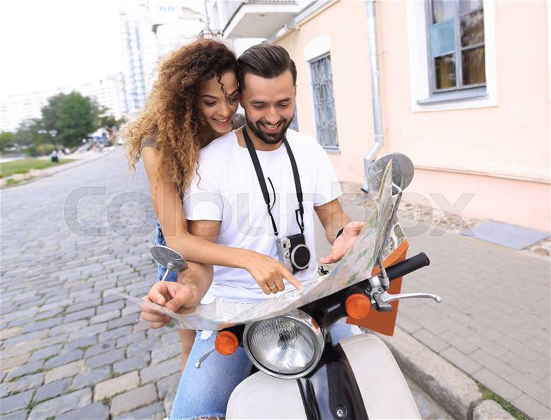 Scooter ride. Beautiful couple riding scooter together, stock photo