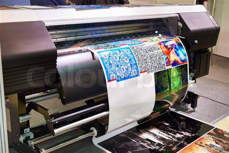 Big rolling wide plotter printer in work, stock photo