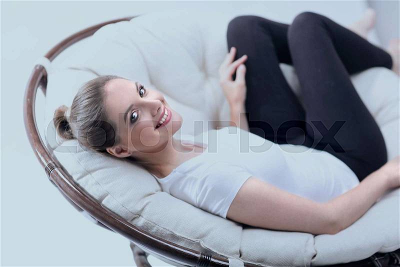 Tired woman resting in an easy chair made of rattan.photo with copy space, stock photo