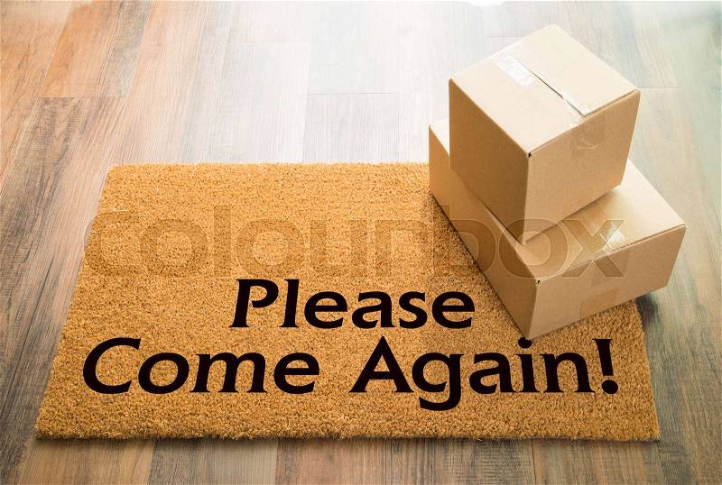 Please Come Again Welcome Mat On Wood Floor With Shipment of Boxes, stock photo