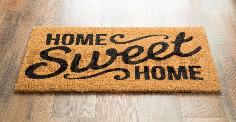 Home Sweet Home Welcome Mat On Wood Floor, stock photo