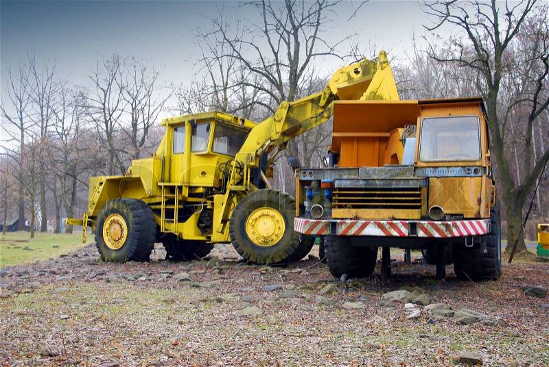 Excavator bulldozer load big truck, stock photo