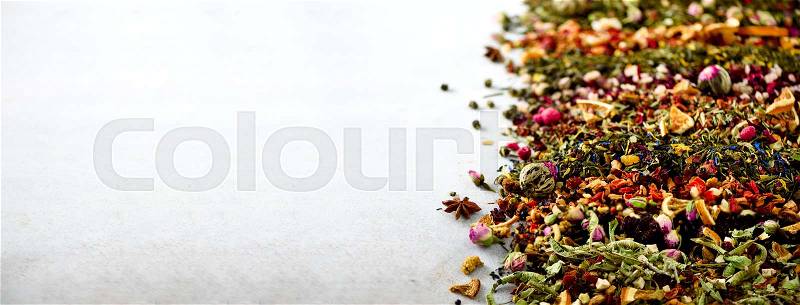Tea background: green, black, floral, herbal, mint, melissa, ginger, apple, rose, lime tree, fruits, orange, hibiscus, raspberry, cornflower, cranberry. Assortment of dry tea, top view. Banner, stock photo