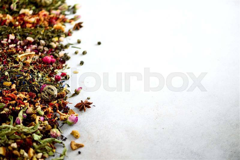 Close up tea background: green, black, floral, herbal, mint, melissa, ginger, apple, rose, lime tree, fruits, orange, hibiscus, raspberry, cornflower, cranberry. Assortment of dry tea, top view, stock photo