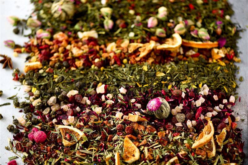 Tea background: green, black, floral, herbal, mint, melissa, ginger, apple, rose, lime tree, fruits, orange, hibiscus, raspberry, cornflower, cranberry. Assortment of dry tea, top view, stock photo