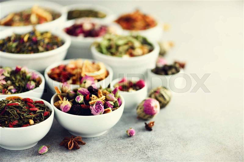 Assortment of dry tea in white bowls. Tea types backgound: green, black, floral, herbal, mint, melissa, ginger, apple, rose, lime tree, fruits, orange, hibiscus, raspberry, cornflower, cranberry, stock photo