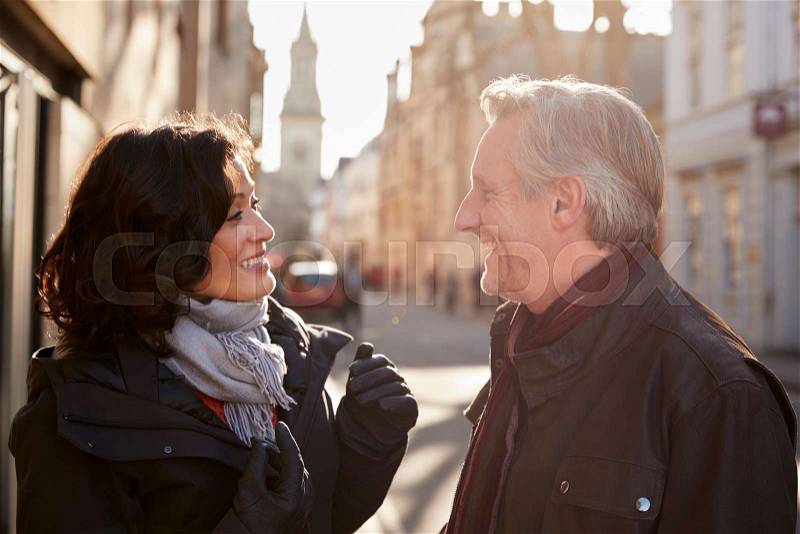 Middle Aged Couple Walking Through City In Fall Together, stock photo