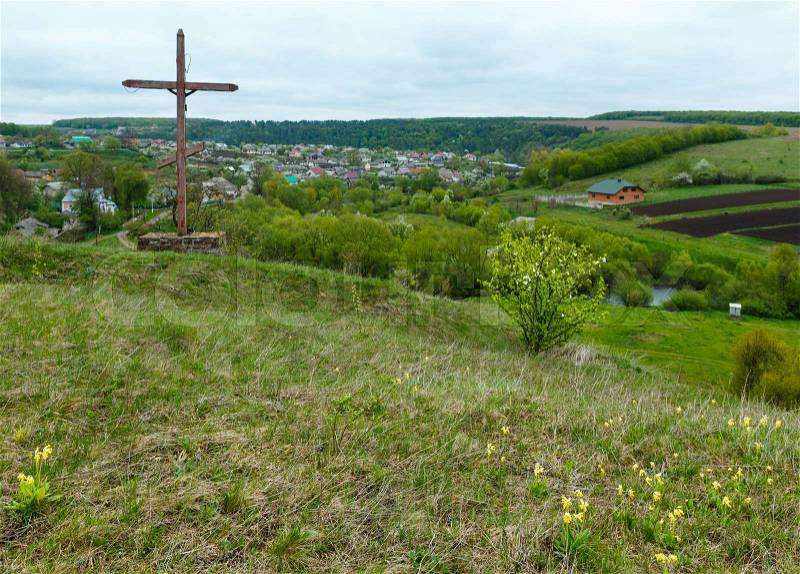 Wooden сhristian religious cross near Rukomysh Cave temple and spring country fields and village, Buchach District, Ternopil Region, Ukraine, stock photo
