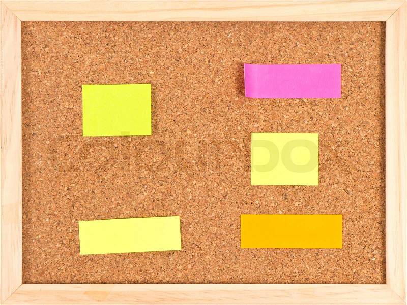 Cork notice board with blank colorful sticker notes, stock photo