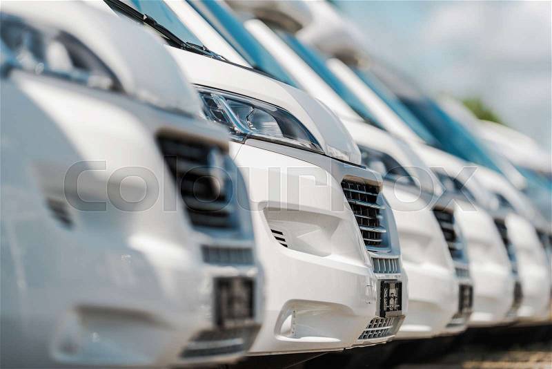 Camper Vans For Sale. RV Industry Theme. Row of Brand New Class B Recreational Vehicles, stock photo