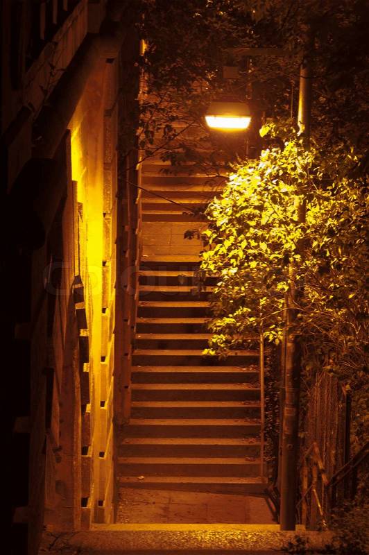 Ancient Passage with steep stairs lit at night, stock photo