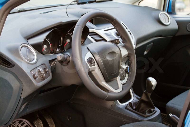 Interior of a modern car, steering wheel and dashboard, stock photo