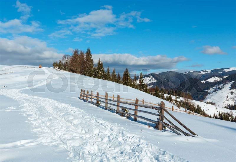 Winter morning scenery picturesque mountain rural snow covered path and footprint on hill top (Ukraine, Carpathian Mountains, tranquility peaceful Dzembronya village outskirts), stock photo