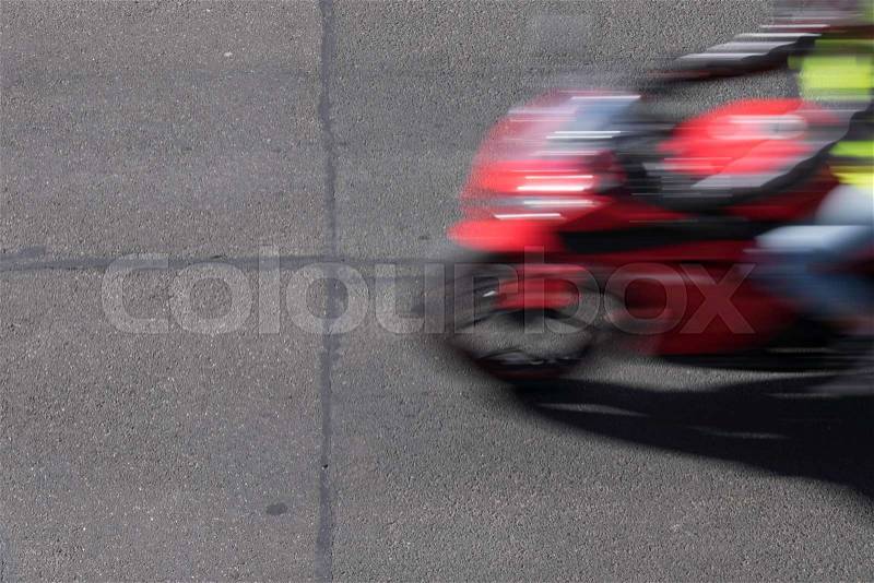 Blurred man and motorcycle on torn grunge asphalt city street in Australia, stock photo