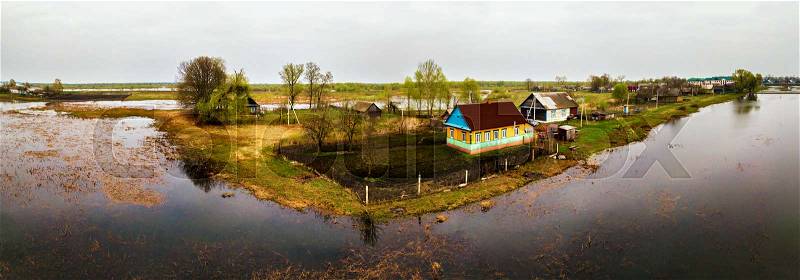 Spring melting river flood aerial panorama. Overflow water at springtime. Drone spate view. Spill landscape, stock photo