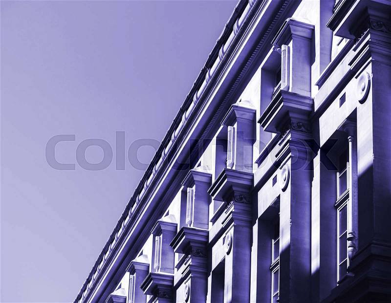 Blue color toned chromacity of parisian building facade in black and white at night pollution city view center of Paris, France, stock photo