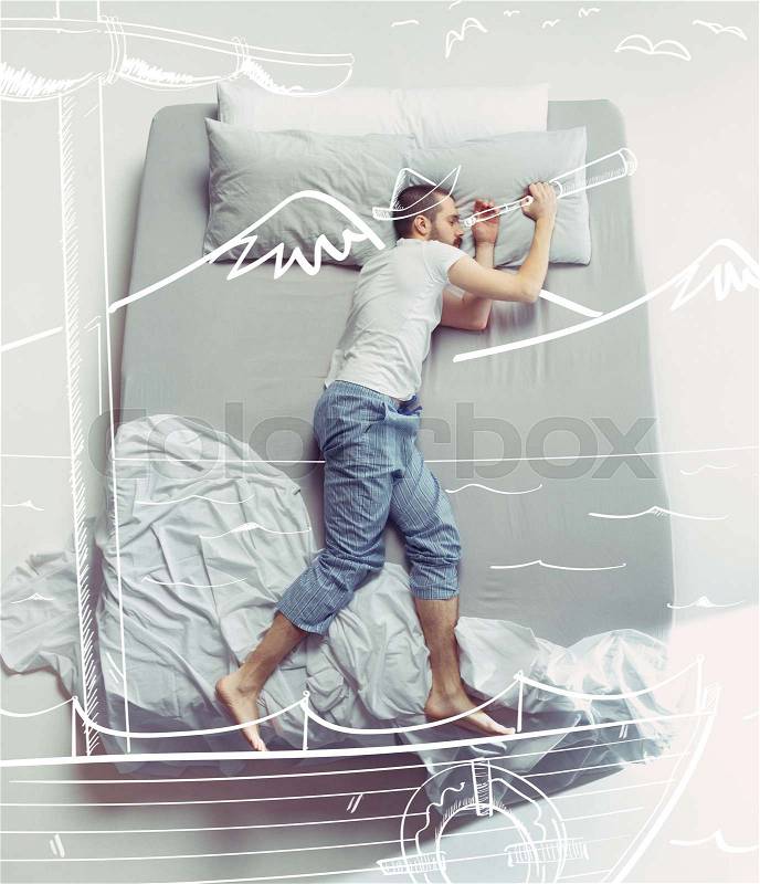 Top view photo of young man sleeping in a big white bed. Dreams concept. He dreaming about travel, ship, captain, trip, sea, vacation, tourism, cruise, summer. Painted dream, stock photo