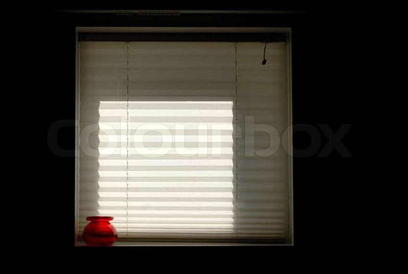 Roller blind and red bowl in a window inside a Danish home, stock photo