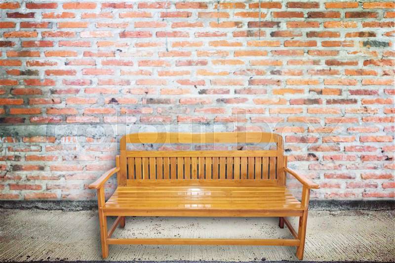 Wood chair on aged street with concrete brick wall texture and background, stock photo