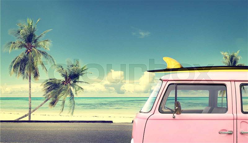 Vintage car in the beach with a surfboard on the roof, stock photo