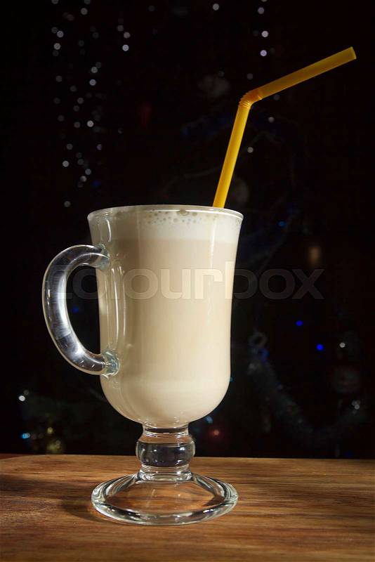Coffee with milk on the background of a Christmas tree, stock photo