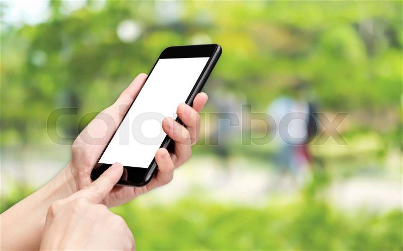 Hand click mobile phone with blur green tree background bokeh light,White screen mock up template for adding your design or your text, stock photo