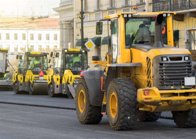 Road re-construction. Road rollers stacking hot asphalt, stock photo