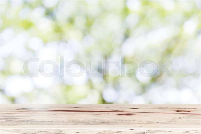 Blank wooden table top for show product with blurred natural background. Picture for add text message. Backdrop for design art work, stock photo