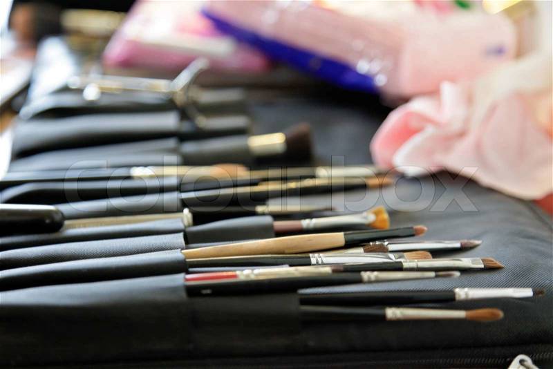 Makeup brushes in professional black bag, stock photo