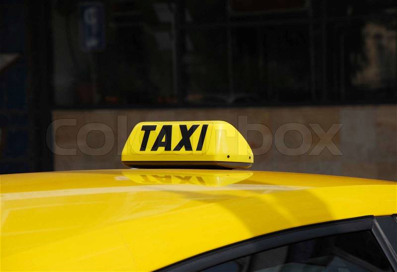 Yellow taxi light on roof, stock photo