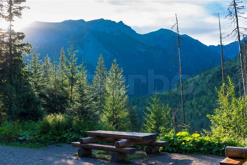 Table and bench for a picnic and a picnic in the mountains at dawn, stock photo