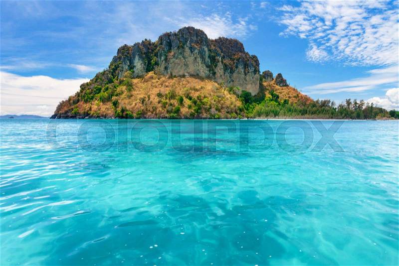 Spectacular scenery the tropical island with the limestone cliffs covered with the vegetation in the crystal clear ocean next to the exotic Phi Phi Islands, the Kingdom of Thailand. Paradise image, stock photo