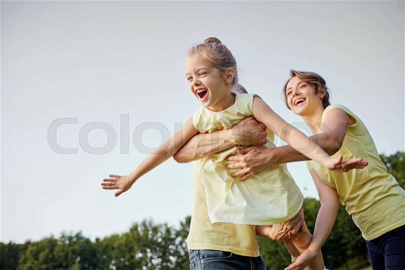 Happy family plays in the park in the summer, stock photo