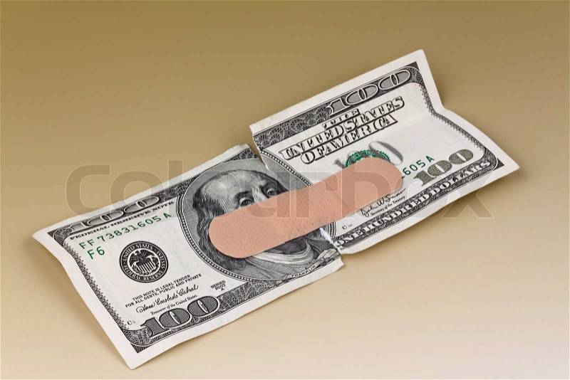 Many dollar bills with a band-aid, stock photo