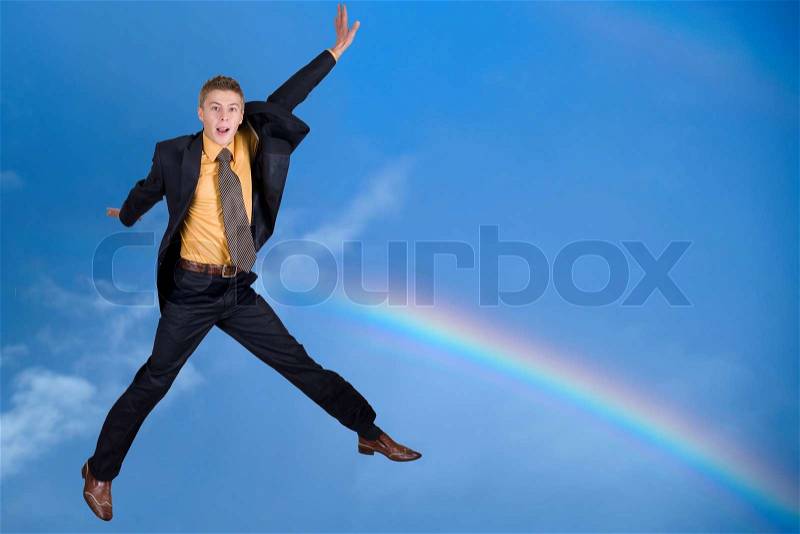 An image of rainbow and jumping man, stock photo