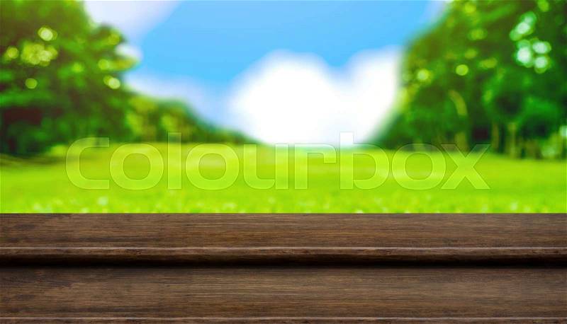 Empty step wood table top with blur tree in park with bokeh light at background,Mock up template for display of your design,Banner for advertise of product,panorama view, stock photo