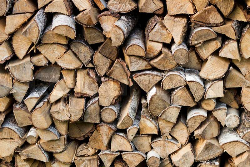 Wooden logs, beams, firewood, frame. A lot of wood. Wooden log wooden background. Fuel. Harvesting firewood for the winter. Logging, stock photo