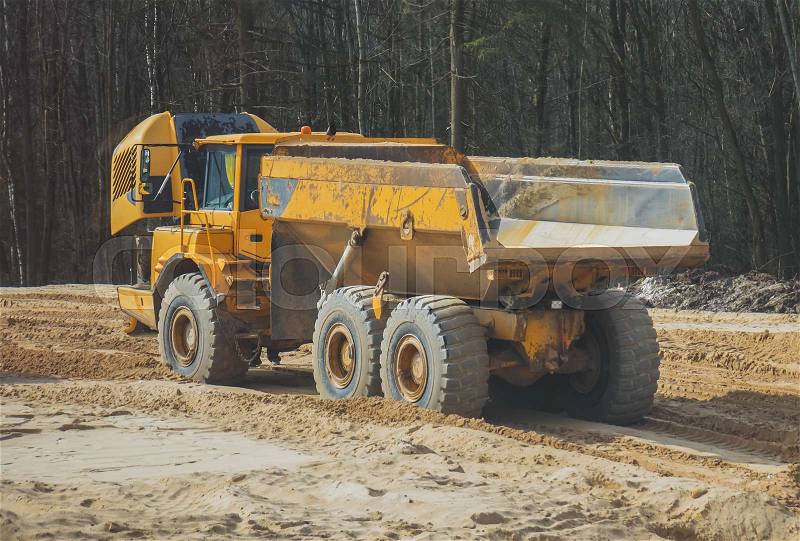 Broken sand tipper truck on construction site, stock photo