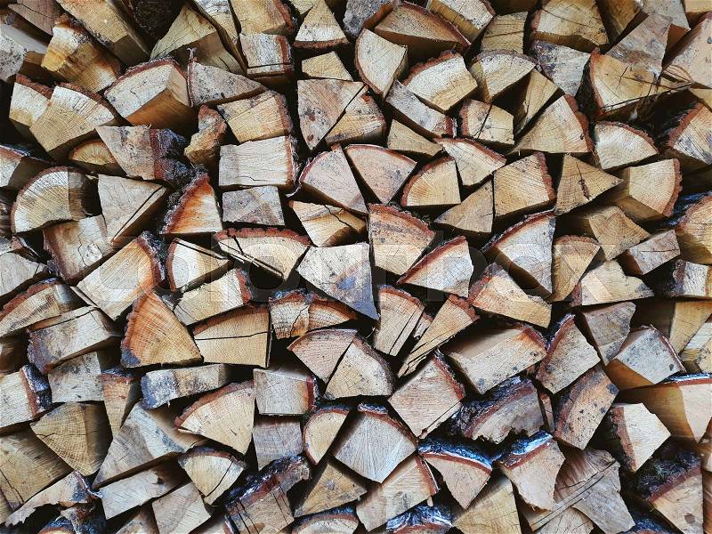 Firewood background, wall firewood, background of dry chopped firewood logs in a pile, stock photo