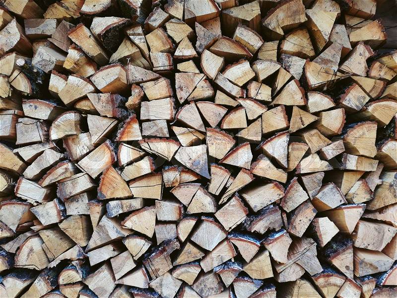 Firewood background, wall firewood, background of dry chopped firewood logs in a pile, stock photo