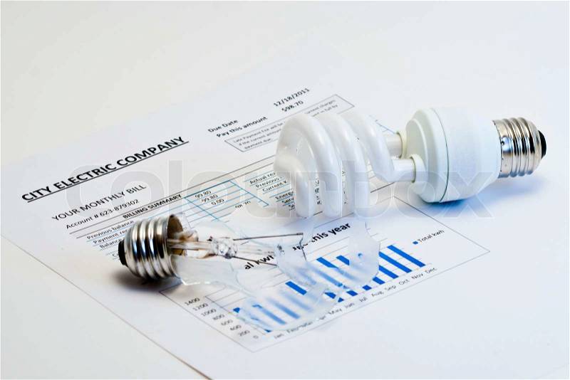 Energy efficient house concept. Energy efficient and broken incandescent bulbs on electric bill, stock photo